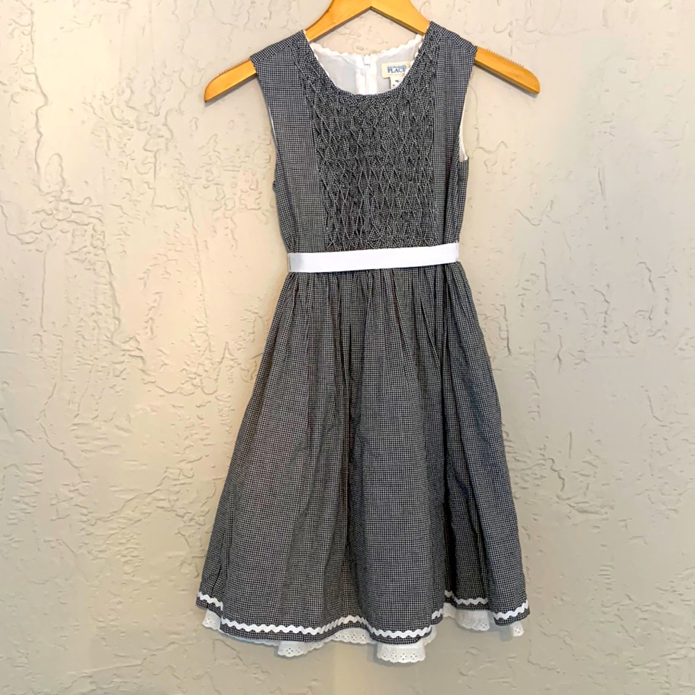 A Childrens Place smocked gingham dress with tie detail. Size 10. Lined